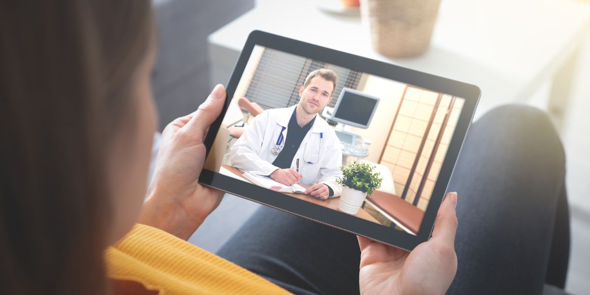 A patient on a tablet video visit with a doctor
