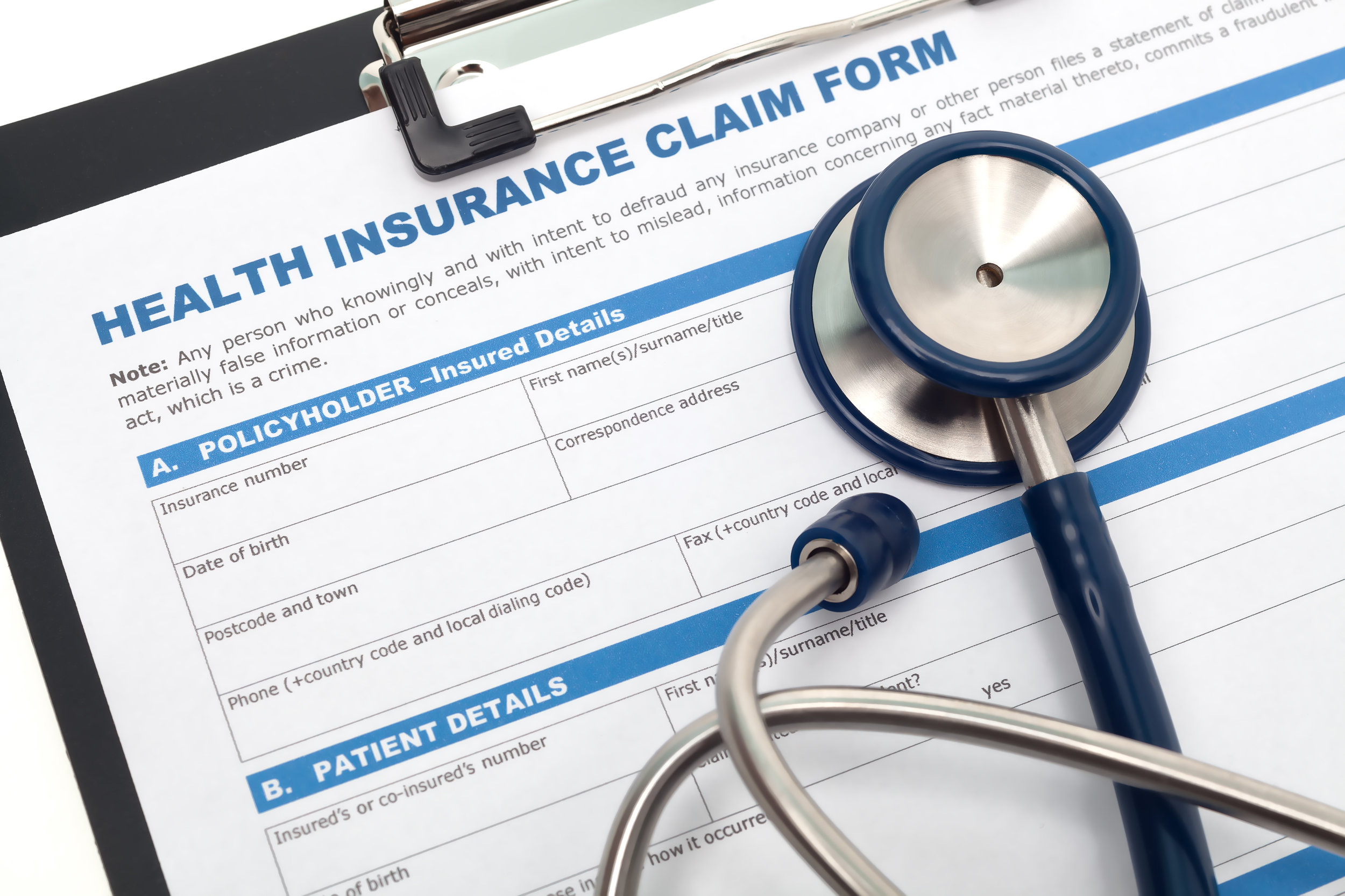 Blank copy of Insurance Claim Form for Physicians on clipboard with stethoscope overlayed