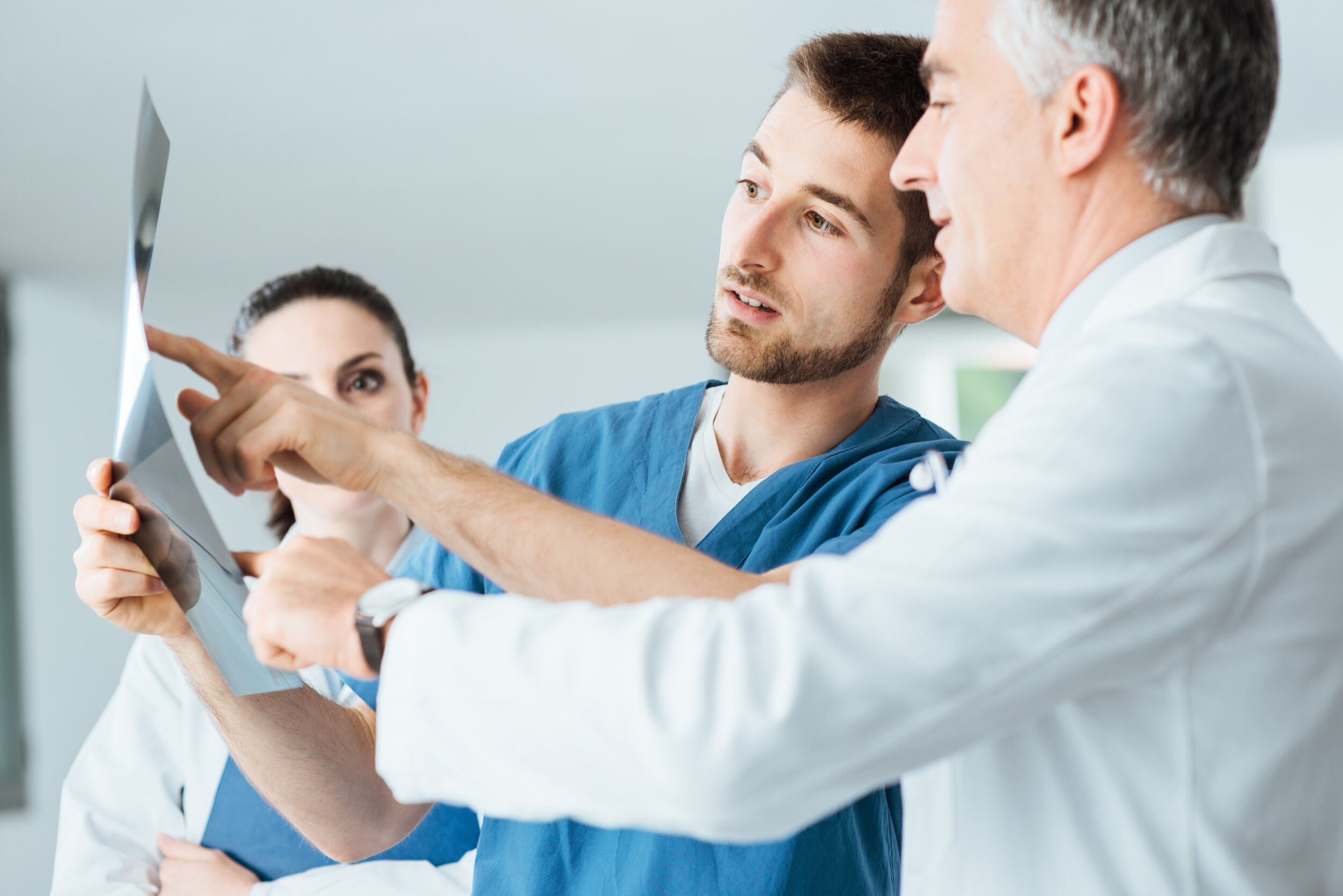 Professional medical team, including primary care doctor, examining patient lab and test results