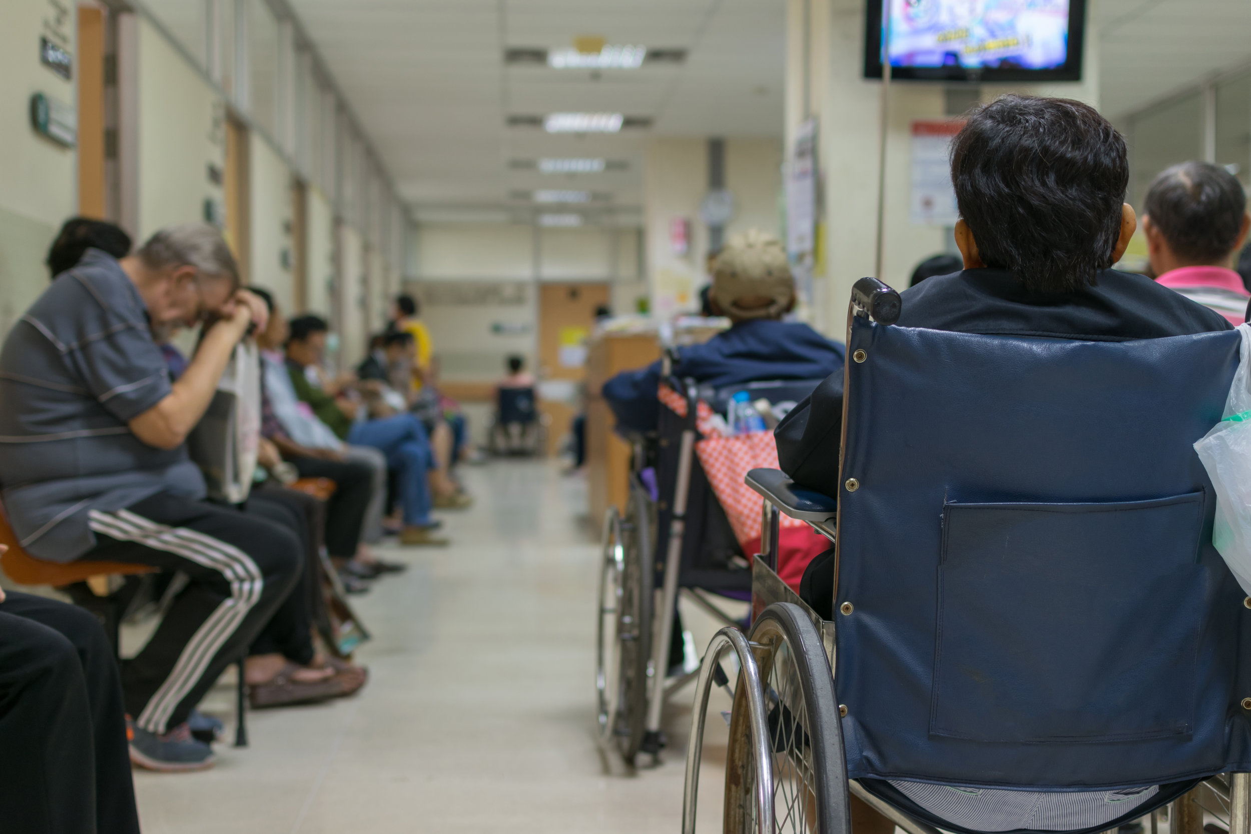 A room packed with tired patients waiting to see their primary care provider