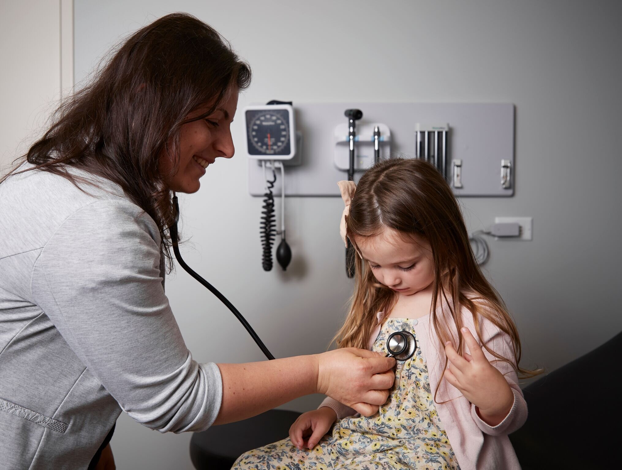 Dr. Lucy Pun, DO (BOARD-CERTIFIED FAMILY PHYSICIAN) examining an young Elevated Patient.