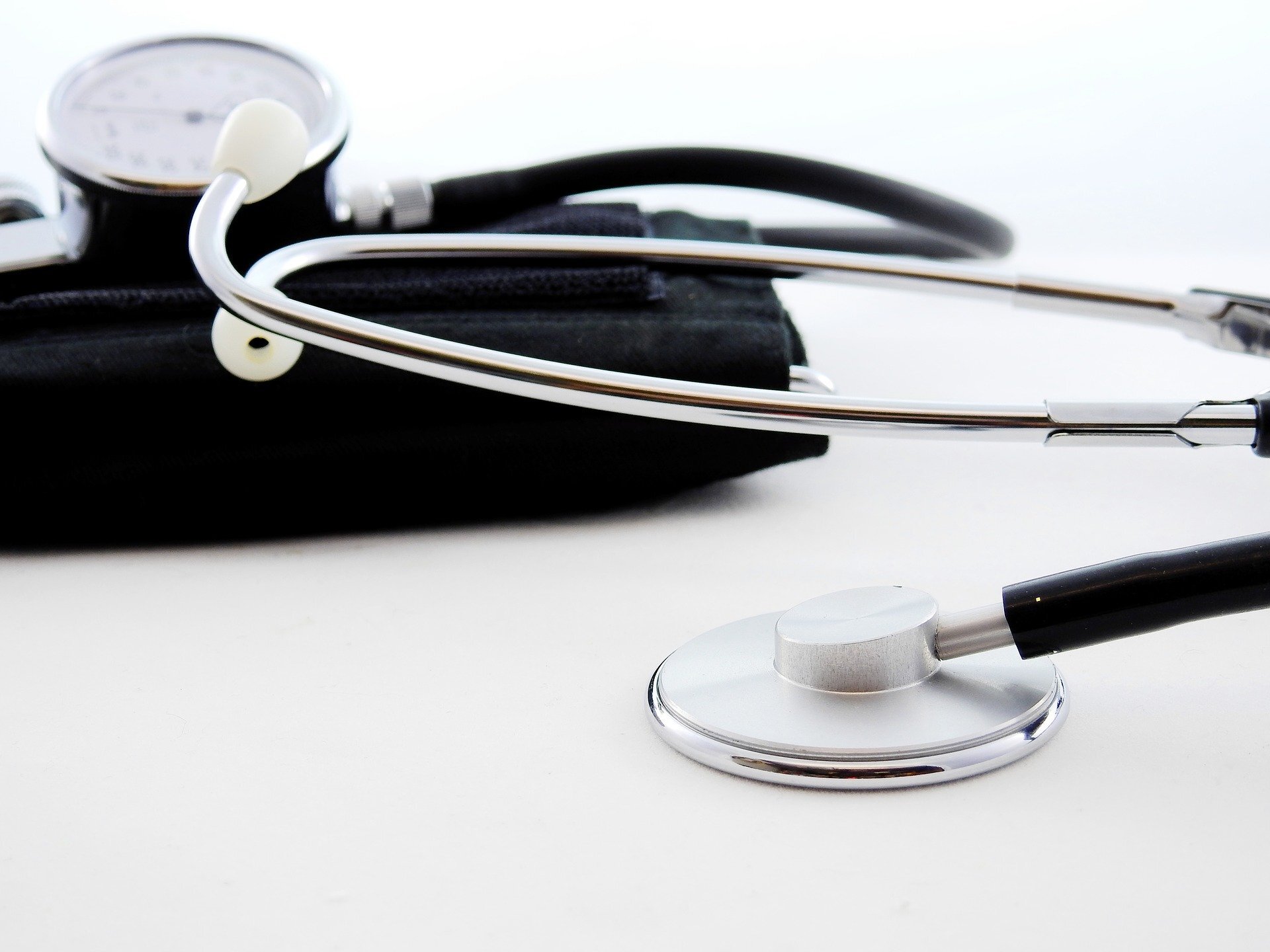 Stethoscope and blood pressure unit on a white surface